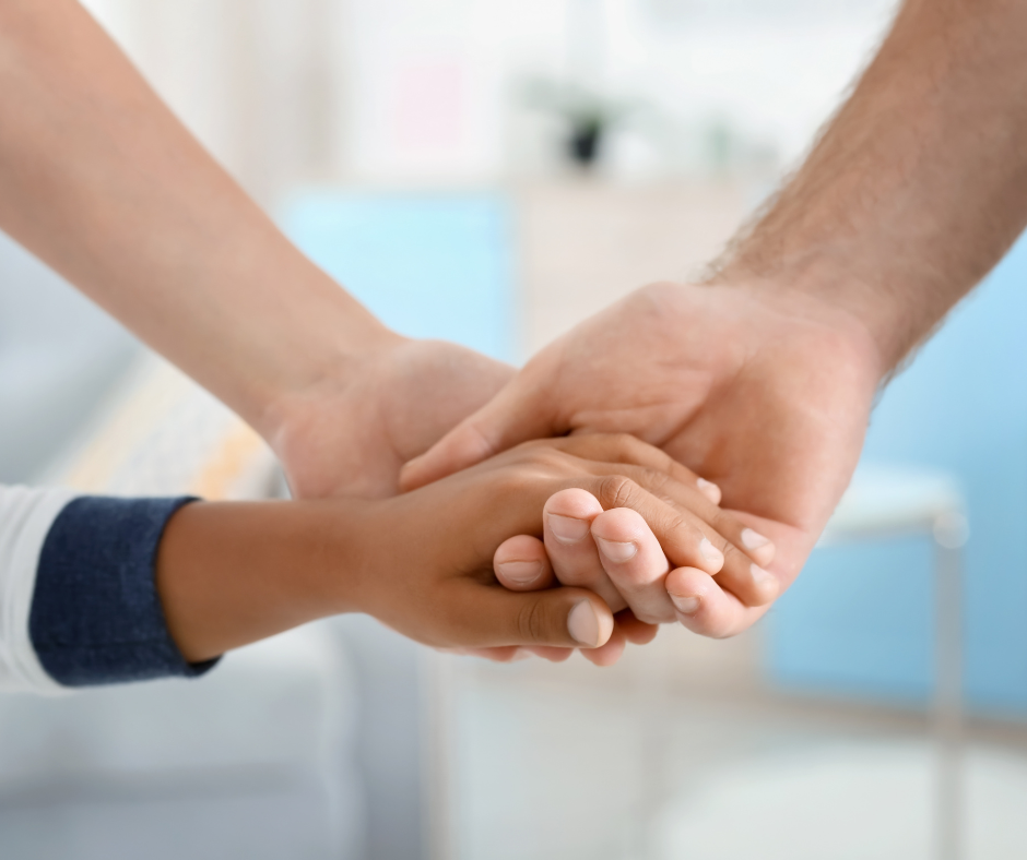 Child and adults holding hands